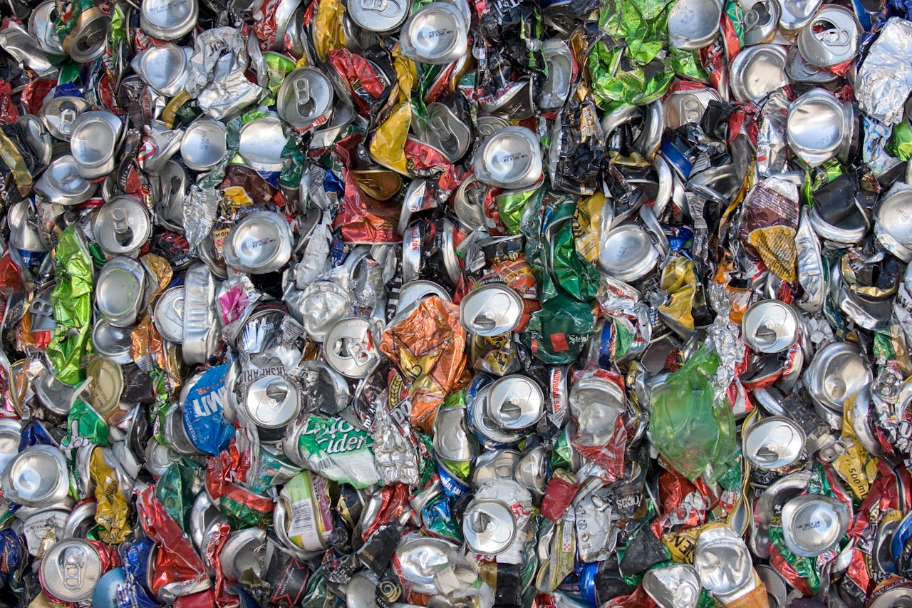 Colorful crushed aluminum cans emphasizing sustainability and recycling.